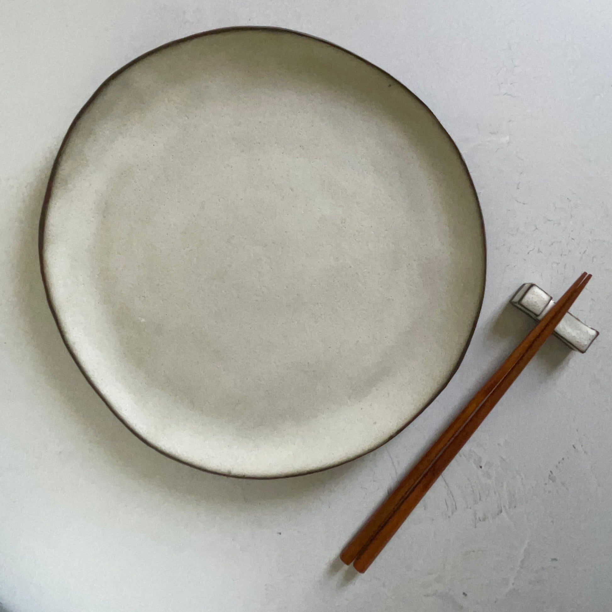 white handmade ceramic dinner plate with chopsticks